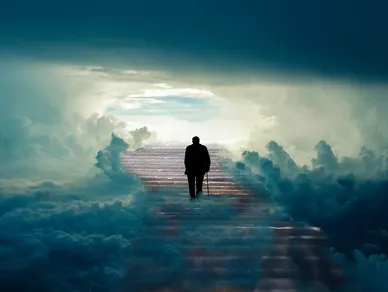 The silhouette of an old man walks with a cane up a long staircase toward the light. He is surround by blue clouds.