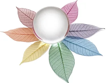 Illustration of a crystal ball on colorful leaves.